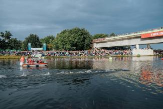 A group of people riding paddle boats on top of a lake by Janik Presser courtesy of Unsplash.