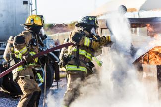three fireman preventing fire during daytime by Matt C courtesy of Unsplash.
